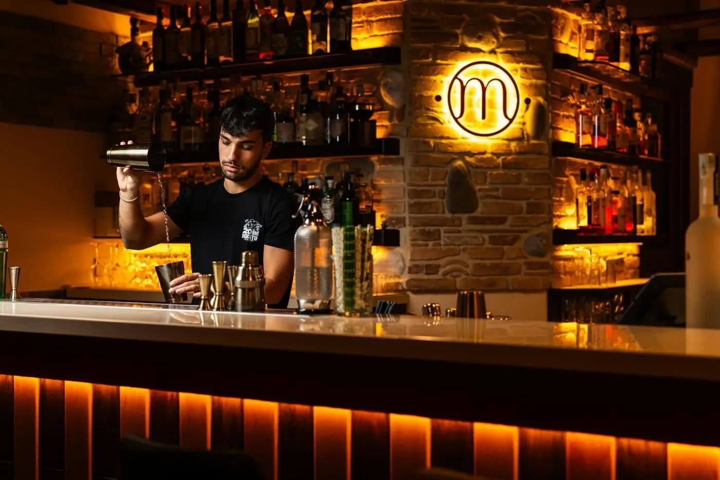 Illustrative photo of a bartender preparing a drink; not this venue or offer